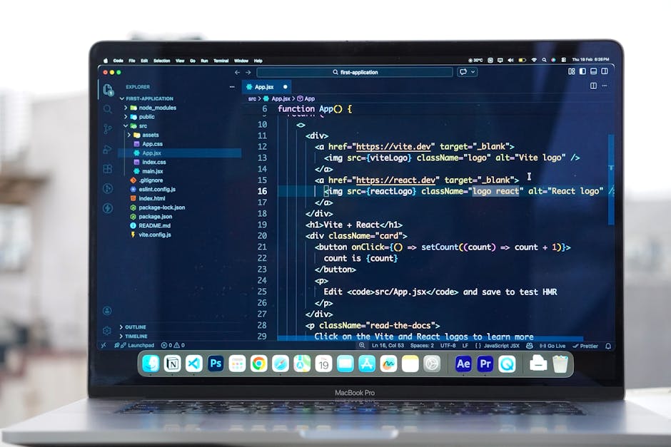 A close-up view of a MacBook Pro laptop screen displaying a code editor with a dark theme. The editor shows a JavaScript file named 'App.jsx' with lines of code related to a React application, includi